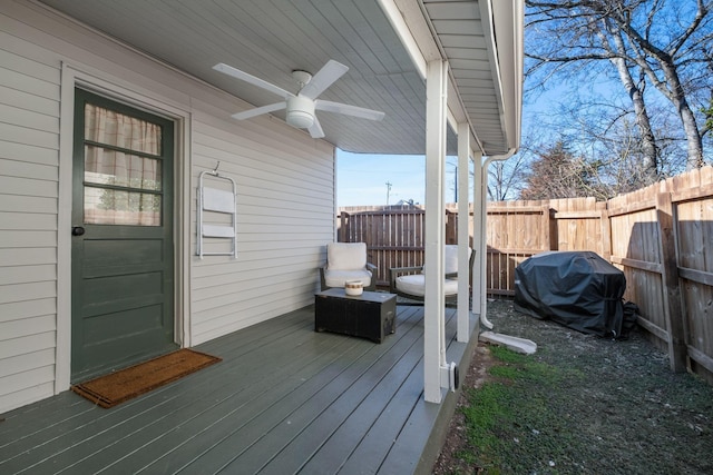 deck with a grill and ceiling fan