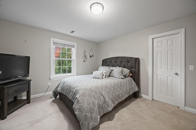 bedroom featuring light carpet