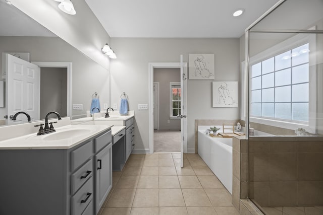 bathroom with vanity, tile patterned floors, and plus walk in shower