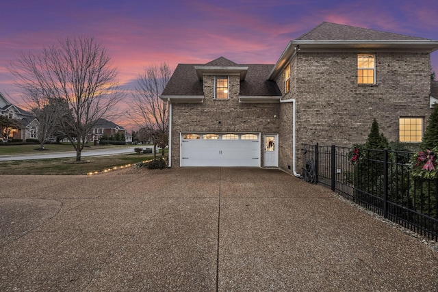 property exterior at dusk with a garage