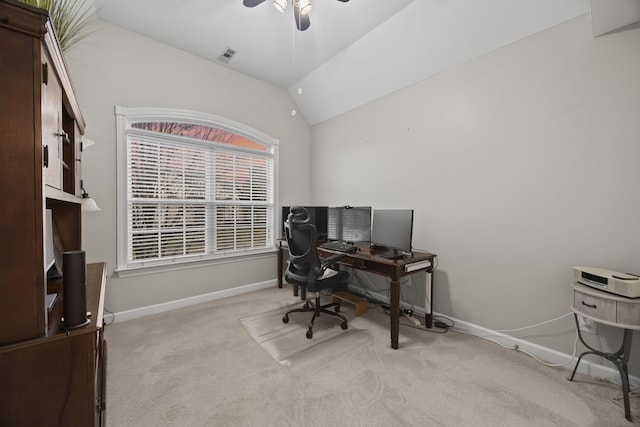 carpeted office space featuring vaulted ceiling and ceiling fan