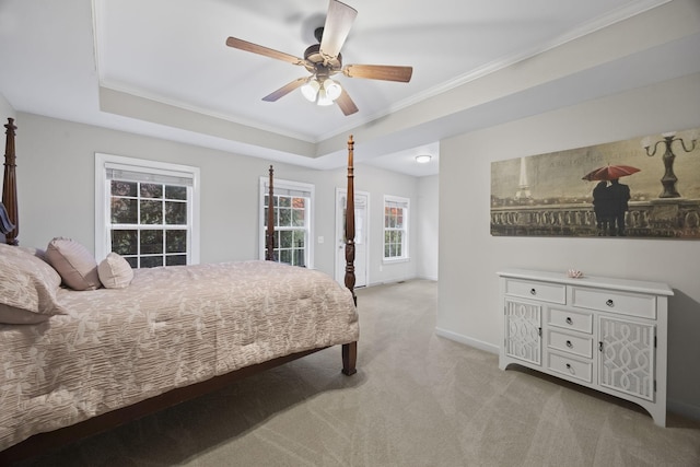 bedroom featuring a raised ceiling, ornamental molding, light carpet, and ceiling fan