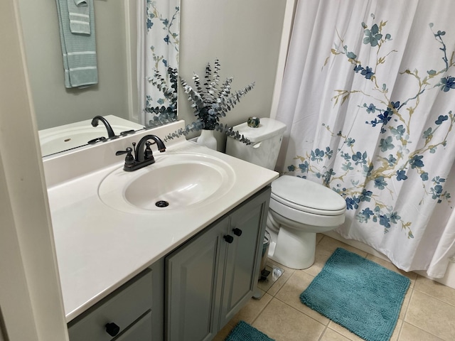 bathroom featuring tile patterned flooring, vanity, and toilet