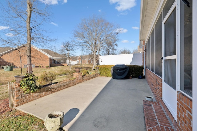 view of patio featuring a sunroom