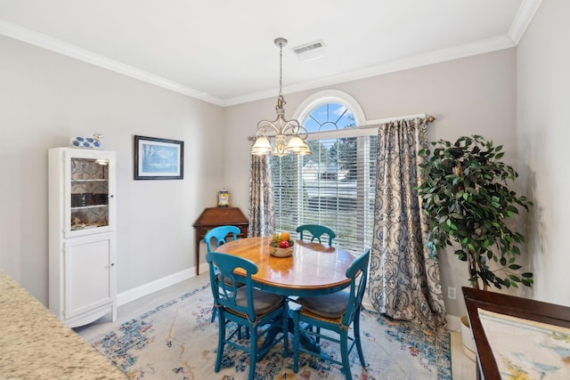 dining room with crown molding and an inviting chandelier