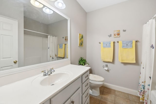 bathroom featuring tile patterned flooring, vanity, curtained shower, and toilet