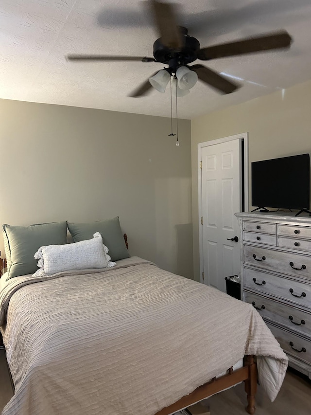 bedroom featuring hardwood / wood-style flooring and ceiling fan