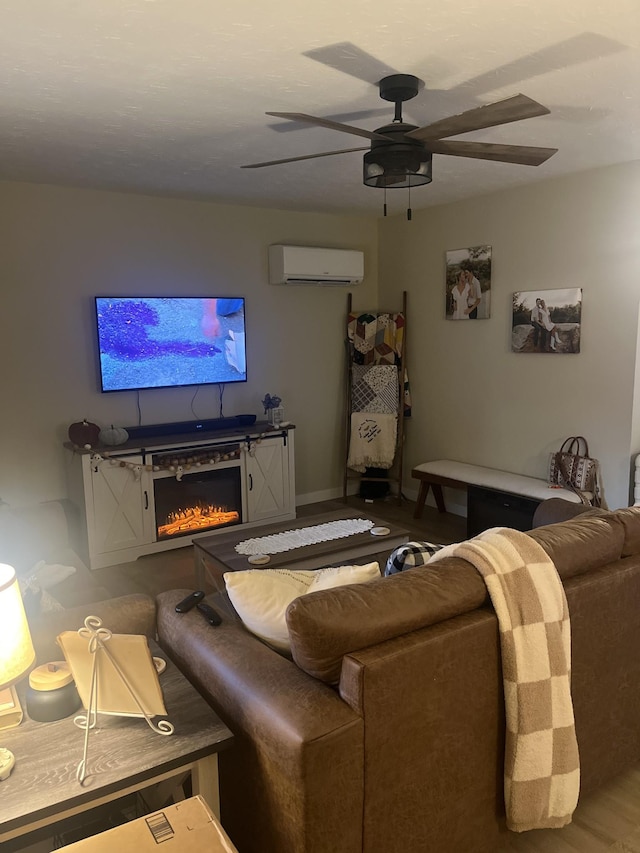 living room with hardwood / wood-style flooring, ceiling fan, and a wall unit AC