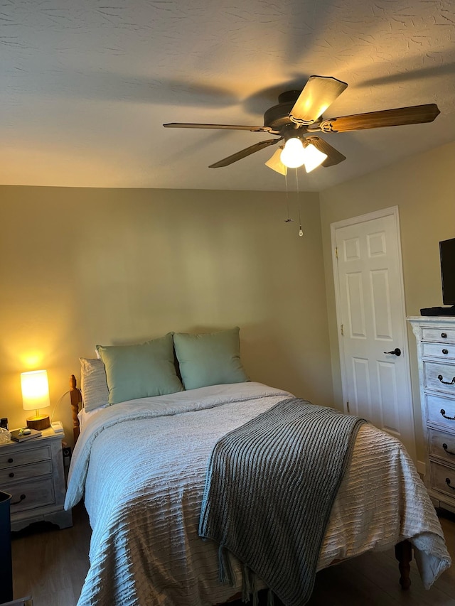 bedroom with hardwood / wood-style floors and ceiling fan