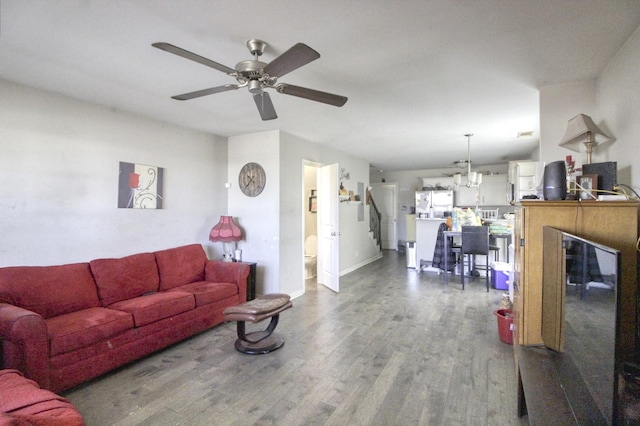 living room with ceiling fan and dark hardwood / wood-style flooring