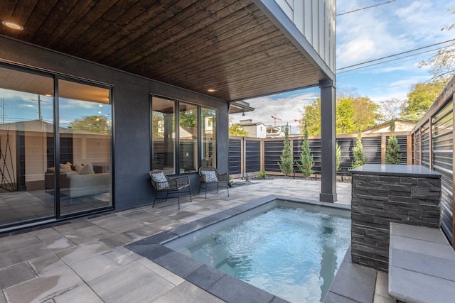 view of swimming pool with a patio area