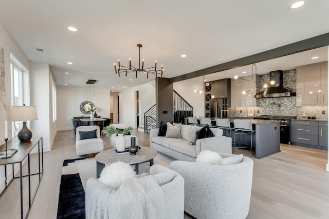 living room featuring an inviting chandelier and light hardwood / wood-style floors