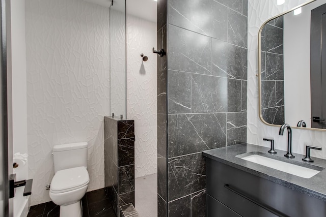 bathroom featuring tile walls, vanity, toilet, and walk in shower