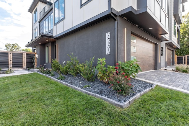 view of property exterior with a garage and a yard