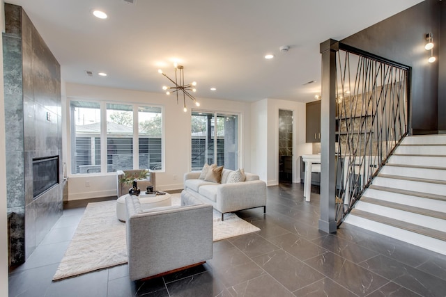 living room with a chandelier and a tile fireplace