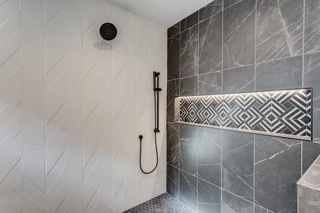 bathroom with tiled shower