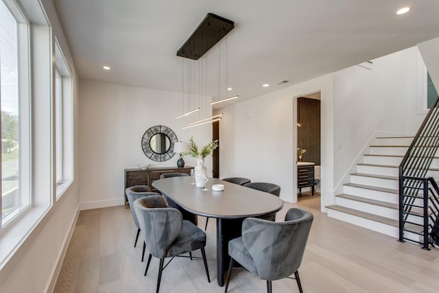 dining space with light wood-type flooring