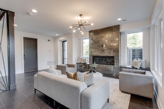 living room featuring a fireplace and a notable chandelier