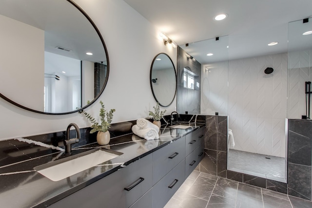 bathroom with vanity, tile walls, and a tile shower