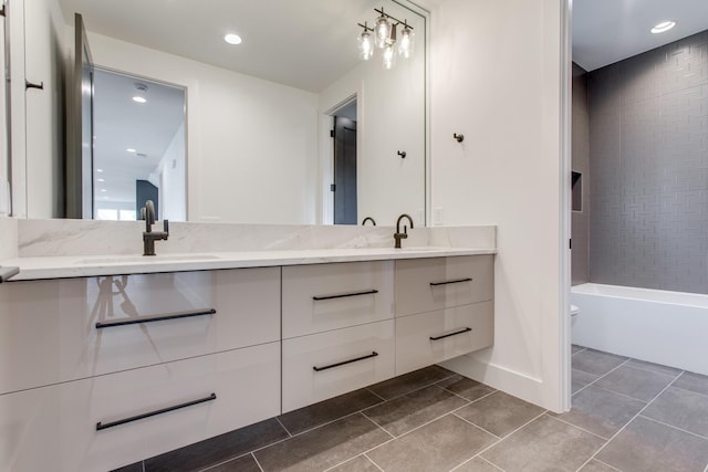 full bathroom featuring vanity, toilet, and tiled shower / bath combo