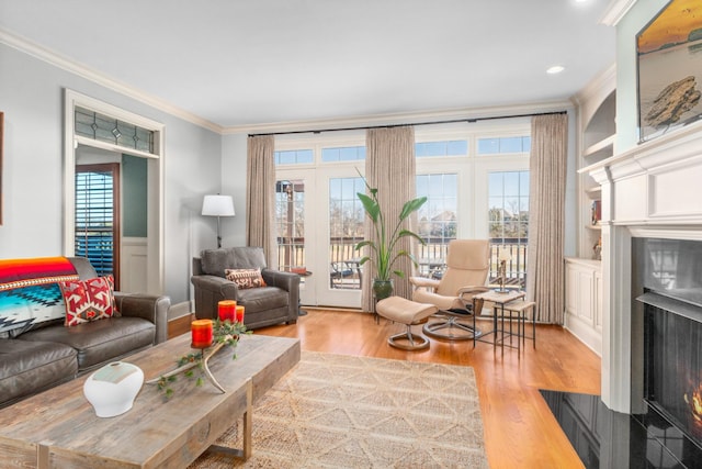 living room featuring ornamental molding and light hardwood / wood-style floors