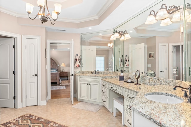 bathroom with tile patterned floors, a chandelier, ornamental molding, vanity, and a raised ceiling