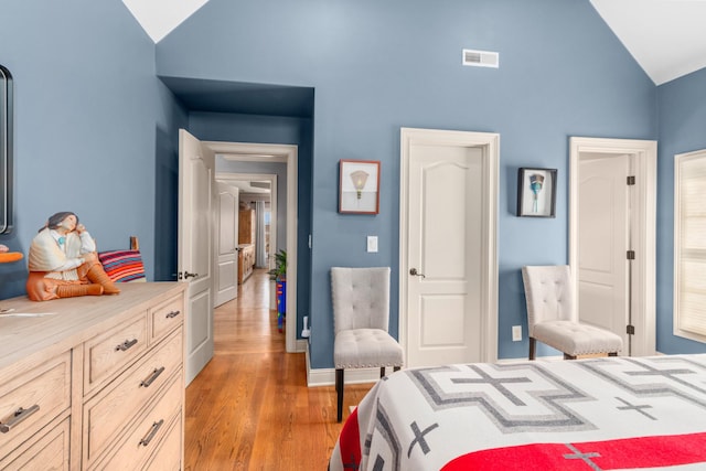 bedroom featuring lofted ceiling and light hardwood / wood-style flooring