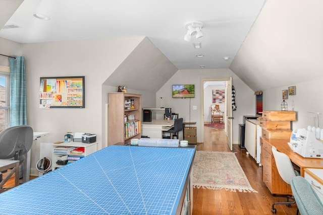 interior space featuring lofted ceiling and hardwood / wood-style floors