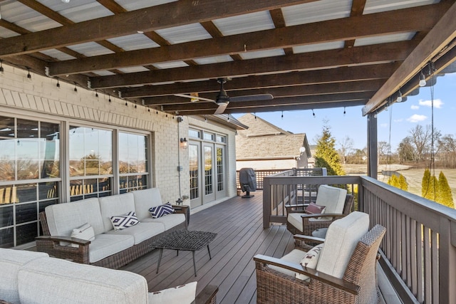 wooden terrace featuring outdoor lounge area, ceiling fan, and french doors