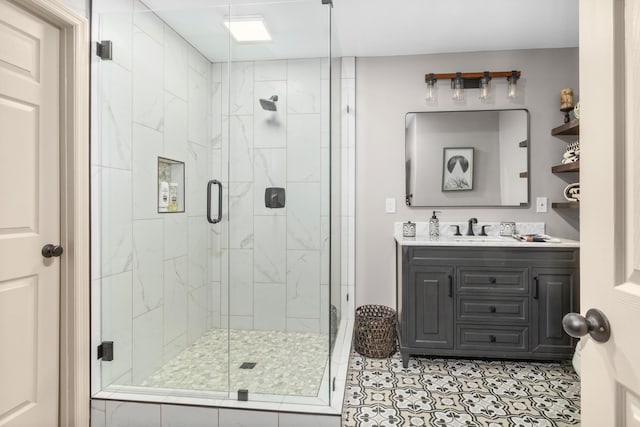 bathroom with an enclosed shower, vanity, and tile patterned flooring