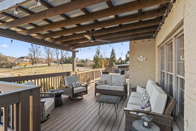 wooden deck featuring an outdoor living space and ceiling fan