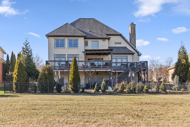 back of property with a yard and a deck