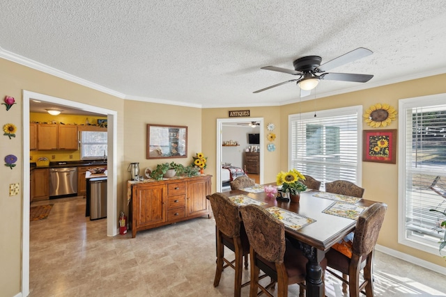 dining space featuring crown molding, plenty of natural light, a textured ceiling, and ceiling fan