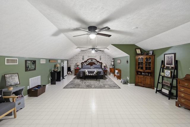 bedroom with brick wall, ceiling fan, lofted ceiling, and a textured ceiling