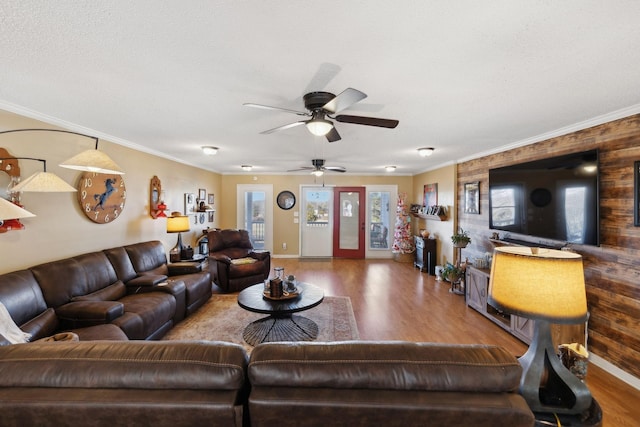 living room featuring ceiling fan, ornamental molding, and hardwood / wood-style floors