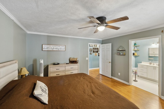 bedroom with ensuite bath, ornamental molding, ceiling fan, a textured ceiling, and light hardwood / wood-style flooring