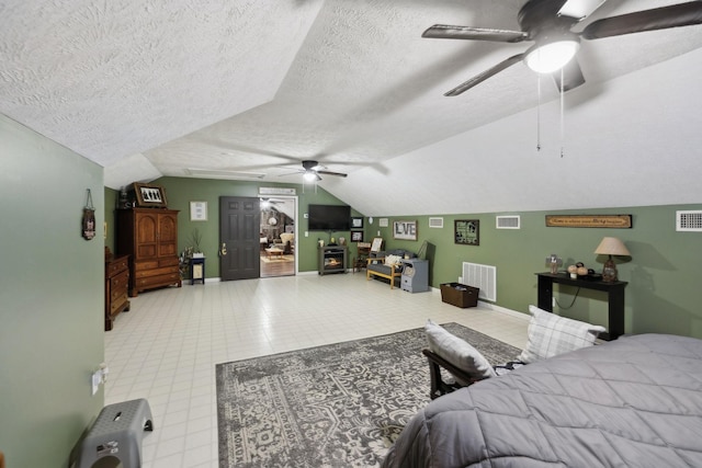 bedroom featuring lofted ceiling, a textured ceiling, and ceiling fan