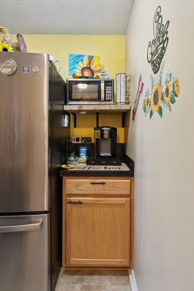 kitchen featuring appliances with stainless steel finishes and a textured ceiling