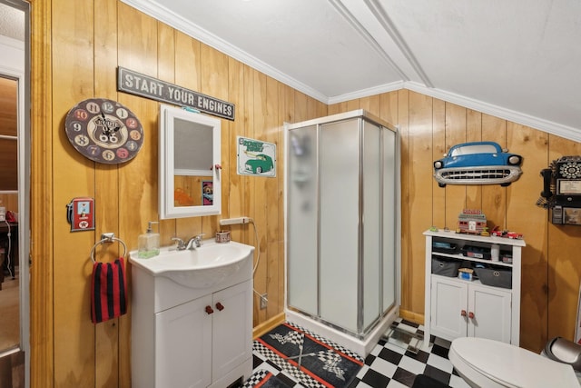 bathroom with toilet, crown molding, vanity, wooden walls, and a shower with door