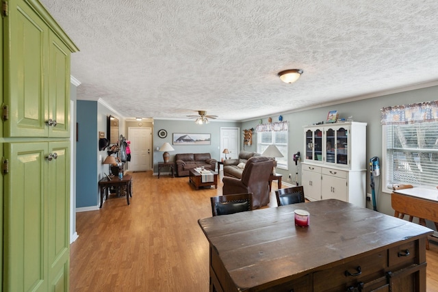 dining space with ornamental molding, plenty of natural light, ceiling fan, and light hardwood / wood-style floors