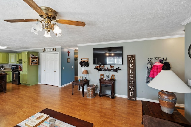 living room with crown molding, hardwood / wood-style floors, a textured ceiling, and ceiling fan