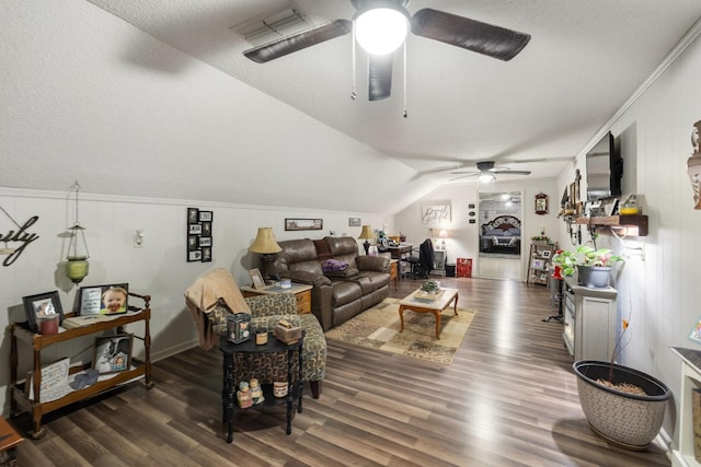 living room featuring ceiling fan, lofted ceiling, dark hardwood / wood-style floors, and a textured ceiling