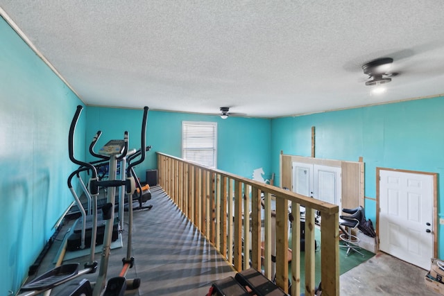 workout room featuring a textured ceiling