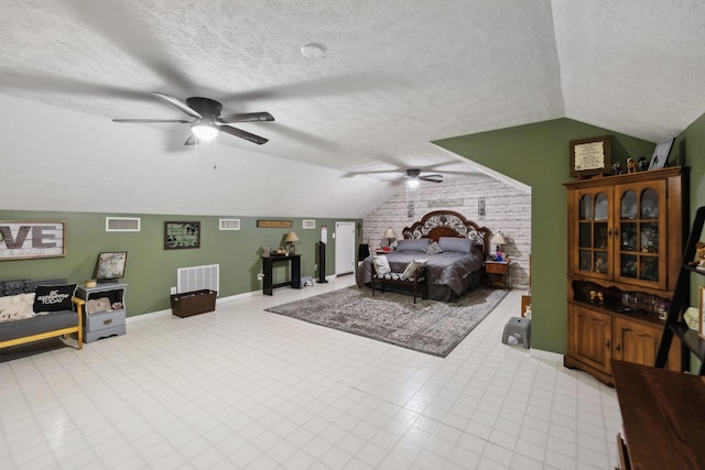 bedroom featuring ceiling fan, vaulted ceiling, and a textured ceiling