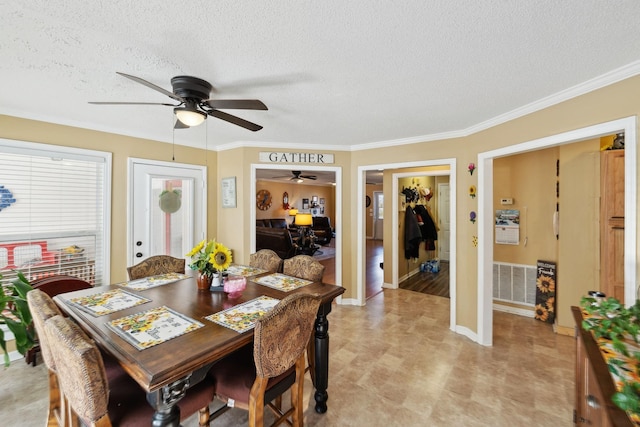 dining space with crown molding, ceiling fan, and a textured ceiling