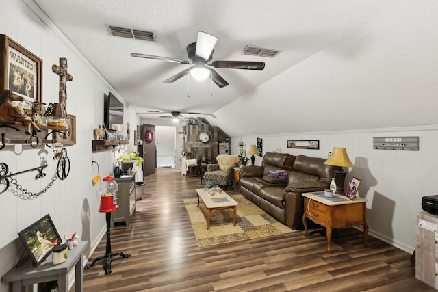 living room featuring dark hardwood / wood-style flooring, ceiling fan, lofted ceiling, and a textured ceiling