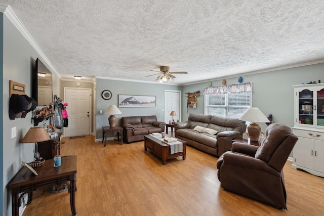 living room with crown molding, ceiling fan, a textured ceiling, and light wood-type flooring