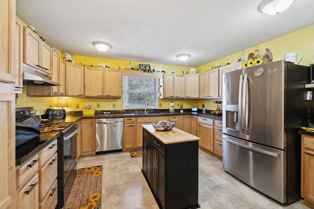 kitchen featuring butcher block countertops, sink, stainless steel appliances, a textured ceiling, and a kitchen island