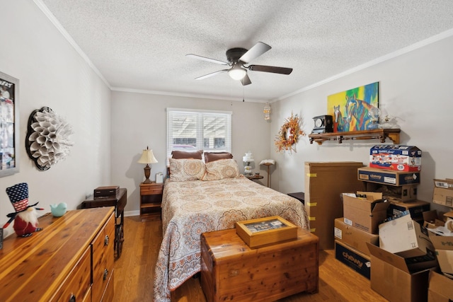 bedroom with crown molding, a textured ceiling, wood-type flooring, and ceiling fan