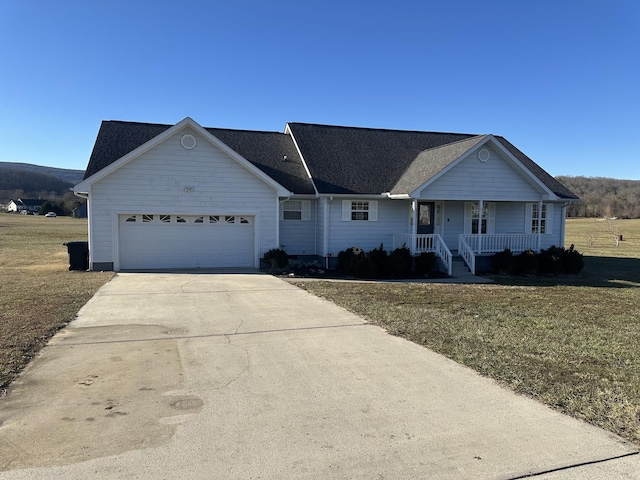 ranch-style house with a garage, a front yard, and a porch